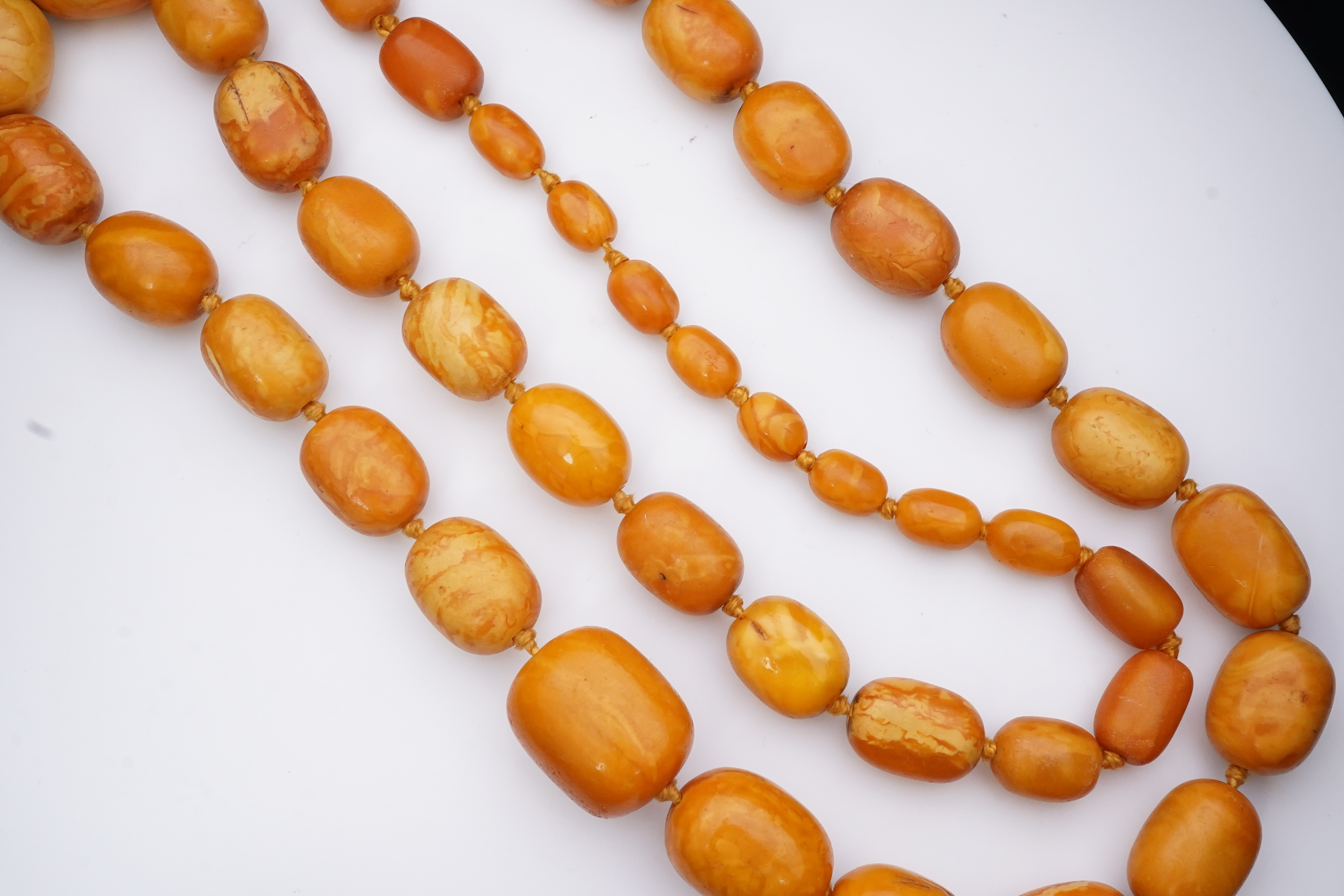 A single strand graduated oval amber bead necklace